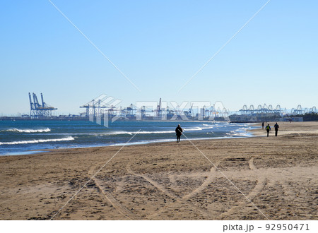gantry cranes and shipping containers in port.  92950471