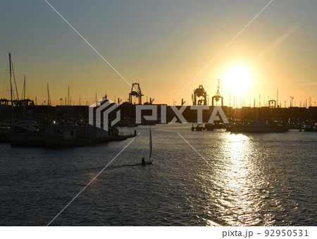 Sailboat on sunset in harbour. Sailing on sea on sailboat on the waves. Sailboat on sunset in harbour. Sailing on sea on sailboat on the waves. 92950531