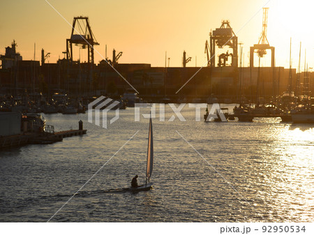 Sailboat on sunset in harbour. Sailing on sea on sailboat on the waves. Sailboat on sunset in harbour. Sailing on sea on sailboat on the waves. 92950534