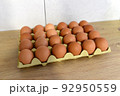 Chicken egg in box. Natural organic eggs in cardboard package on table in kitchen. 92950559