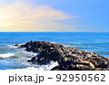 Breakwater with waves in sea. Waves at the stone pier. 92950562