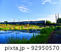 Train on bridge over river in wild. Passenger train passes over a railway bridge over a wild river 92950570
