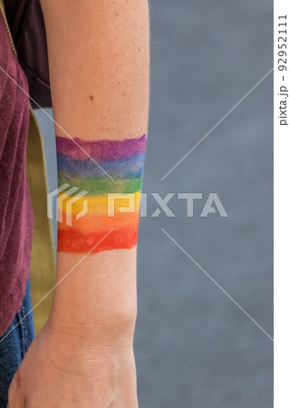LGBTQ community colorful rainbow flag symbol painted at arm. Colors are symbol for respect, diversity, solidarity, equality, tolerance and liberty. Support movement for love, peace and freedom. 92952111