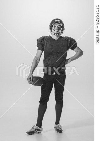 Portrait of young man, american football player posing. Black and white photography. Smiling, laughing, Winning championship 92953121