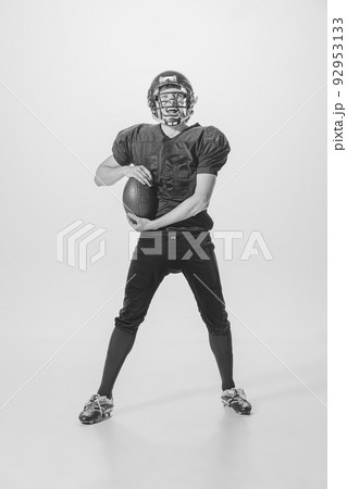Portrait of young man, american football player posing. Black and white photography. Motivated sportsman. Winning game 92953133