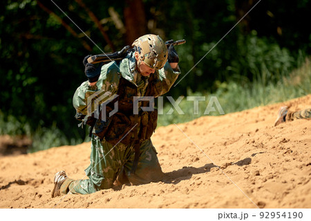 Special forces soldier with weapon take part in military maneuver. War, army, technology and people concept Special forces soldier with weapon take part in military maneuver. War, army, technology and people concept 92954190