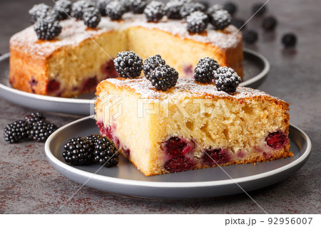 Slice of an fresh blackberry cake closeup in the plate. Horizontal 92956007
