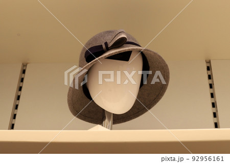 A mannequin stands on a showcase in a store. 92956161