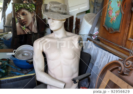 A mannequin stands on a showcase in a store. A mannequin stands on a showcase in a store. 92956629