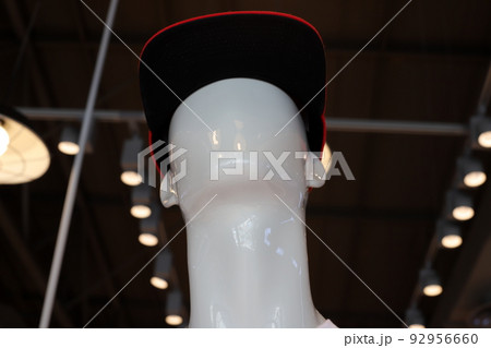 A mannequin stands on a showcase in a store. A mannequin stands on a showcase in a store. 92956660