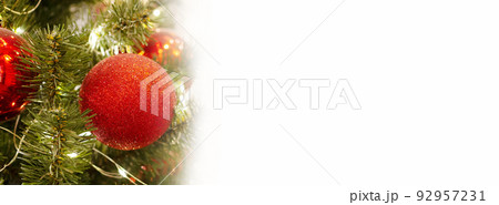 New Year's banner with a red Christmas tree toy and space for text. Copy space. Layout for design. Close-up. White background. 92957231
