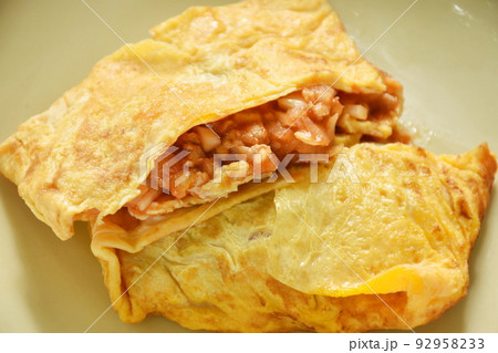 fried mashed pork with tomato and onion stuffed in Thai egg omelets on dish 92958233