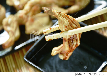 crispy fried duck innards on plate dipping with sweet black soy sauce crispy fried duck innards on plate dipping with sweet black soy sauce 92958235