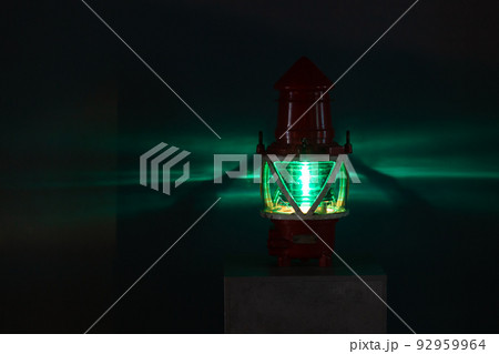Green marine light glows in a dark, close up 92959964