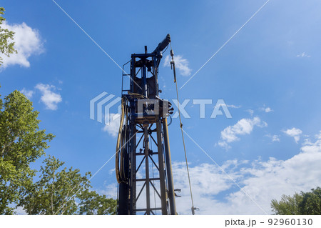 On a private plot of land, a portable hydraulic water well drilling rig with water extraction 92960130