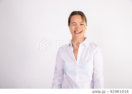 Portrait of cheerful young businesswoman sticking out tongue 92961016