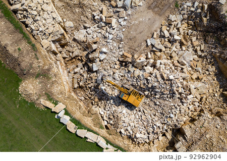 Aerial view of excavator working in a limestone quarry 92962904