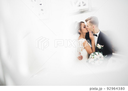 Perfect wedding couple holding luxury bouquet of flowers 92964380