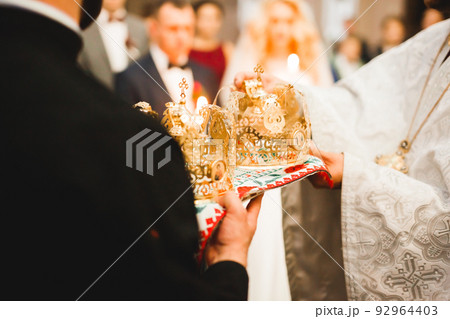 Golden crowns lying on the table in church Golden crowns lying on the table in church 92964403