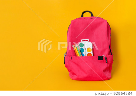 Back to school, backpack with school supplies and stationery on yellow background 92964534