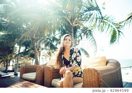 young pretty woman at swimming pool relaxing in chair, fashion look in lingerie at hotel, lifestyle people concept close up young pretty woman at swimming pool relaxing in chair, fashion look in lingerie at hotel, lifestyle people concept close up 92964599