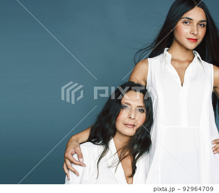 cute pretty teen daughter with mature mother hugging, fashion style brunette, lifestyle people concept close up 92964709