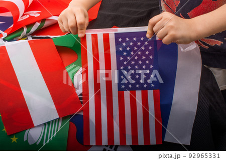Child hand holding an American flag in hand 92965331