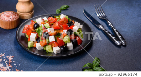 Greek salad with fresh vegetables, feta cheese and black olives Greek salad with fresh vegetables, feta cheese and black olives 92966174