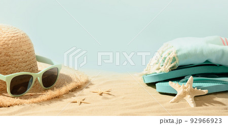 Beach straw sun hat, seashells and eyeglasses on sand. Summer holiday vacation. Beach straw sun hat, seashells and eyeglasses on sand. Summer holiday vacation. 92966923