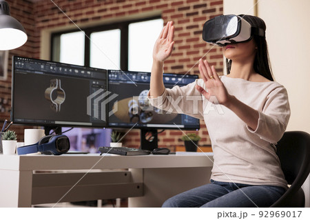 Engineer using vr glasses to manufacture gears product with virtual reality technology and cad software on computer. Technician engineering industrial machinery turbine with interactive headset. 92969017