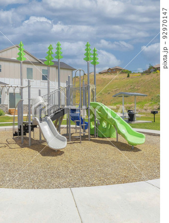 Vertical White puffy clouds Circular playground outside the fenced residential area at Utah Vertical White puffy clouds Circular playground outside the fenced residential area at Utah 92970147