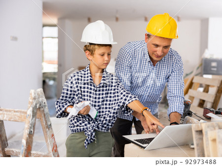 Father with son planning renovating of home Father with son planning renovating of home 92973488