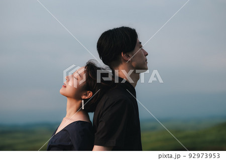 自然の中で背中合わせの男女 自然の中で背中合わせの男女 92973953