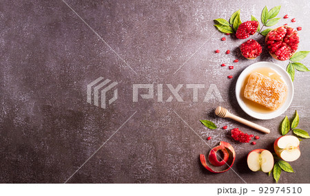 Rosh hashanah (Jewish New Year holiday), Concept of traditional or religion symbols on dark stone background. Rosh hashanah (Jewish New Year holiday), Concept of traditional or religion symbols on dark stone background. 92974510