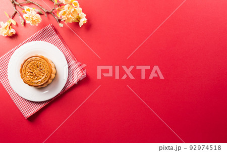Chinese Mid-Autumn Festival concept made from mooncakes, tea and plum blossom. 92974518