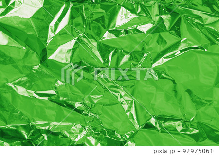 Green lime foil shiny texture, abstract wrapping paper for background and design art work. Green lime foil shiny texture, abstract wrapping paper for background and design art work. 92975061