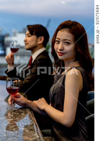 バーのカウンターでシャンパンを飲むカップル バーのカウンターでシャンパンを飲むカップル 92975684