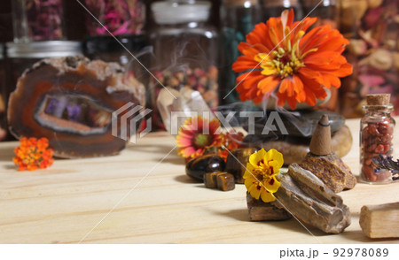 Agatized Coral With Quartz Crystals and Flowers on Meditation Table 92978089