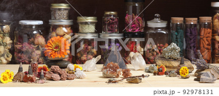 Meditation Altar With Rock Crystals and Flowers. Jars of Herbs in Background 92978131