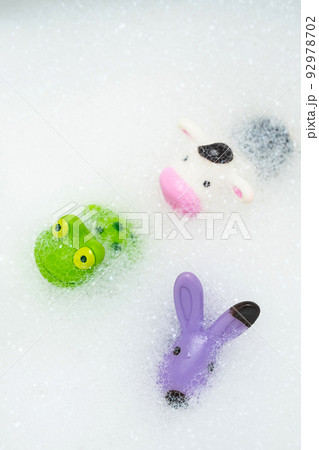 Rubber toys in bath bubbles. Colourful animal toys in soapy foam. Rubber toys in bath bubbles. Colourful animal toys in soapy foam. 92978702
