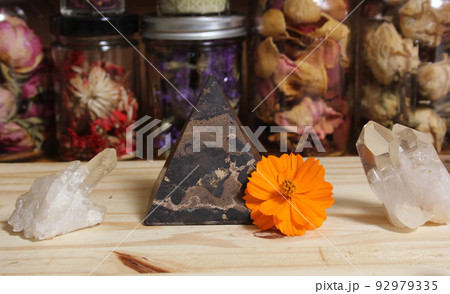 Quartz Crystals and Stone Pyramid With Flower. Relaxation and Meditation Decor Quartz Crystals and Stone Pyramid With Flower. Relaxation and Meditation Decor 92979335