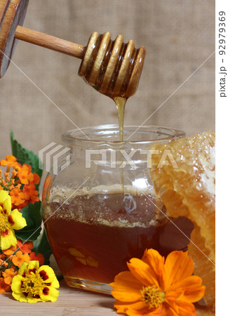 Fresh Honey With Honeycomb and Flowers in Rustic Kitchen Fresh Honey With Honeycomb and Flowers in Rustic Kitchen 92979369