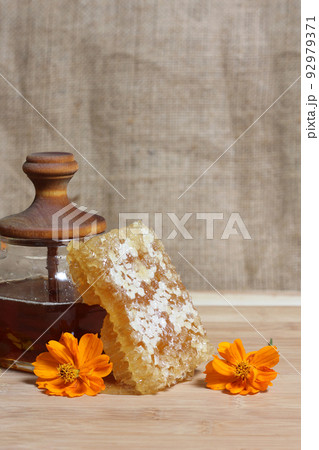 Fresh Honey With Honeycomb and Flowers in Rustic Kitchen Fresh Honey With Honeycomb and Flowers in Rustic Kitchen 92979371