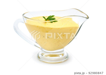 Tasty yellow hollandaise sauce in glass bowl gravy boat isolated on white background 92980847