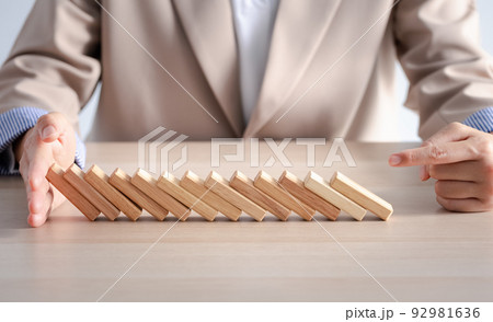 wood block row fallen by woman finger 92981636