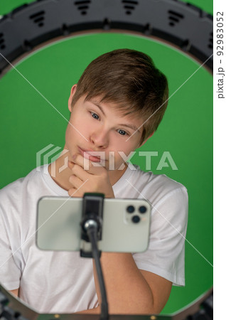 Modern boy taking selfies with a ring light Modern boy taking selfies with a ring light 92983052