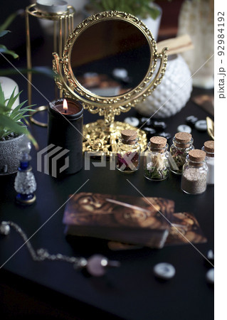 Blurred esoteric magic objects tarot cards on witch table altar 92984192