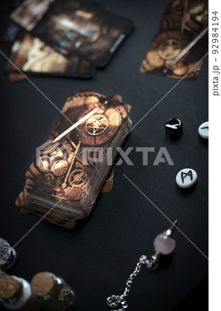 Blurred esoteric magic objects tarot cards on witch table altar 92984194