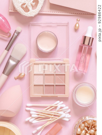 Natural skin care products and decorative cosmetics on light pink, top view 92986422