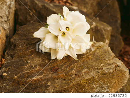 Wedding bouquet of white lilies on a stone texture 92986726